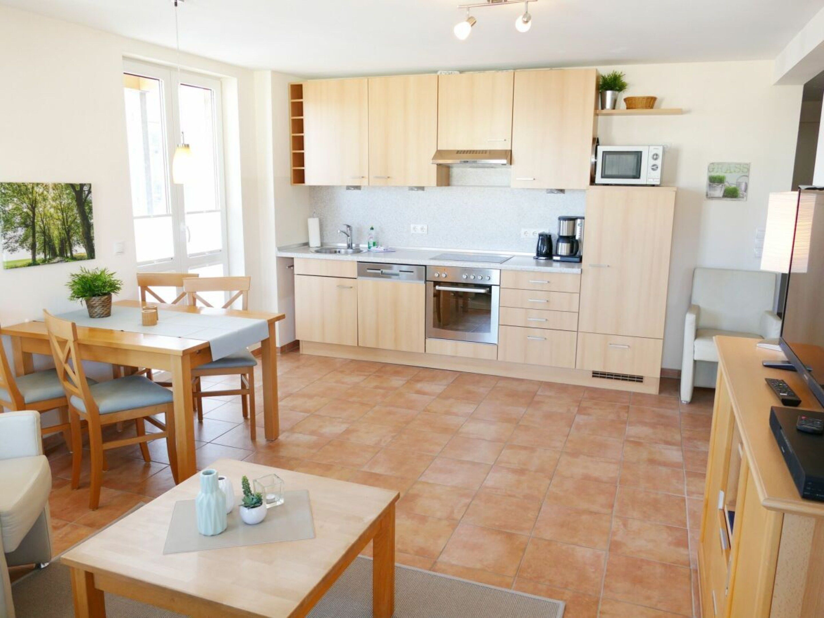 A modern kitchen with wooden cabinets, a microwave, and a coffee maker.
