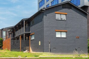 A modern building with a brick facade, multiple windows, and a visible address number. - Legends Lounge Glam Suite On Music Row IG Worthy (Nashville)