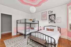 A bedroom with bunk beds, a bedside table, a hanging light fixture, and motivational posters on the wall. - Dolly's Historic Mansion IG Worthy Near Broadway (Nashville)