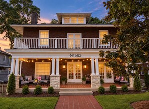 A two-story house with a balcony, numbered 1612, featuring a porch with outdoor seating and string lights. - Historic Mansion Dolly Glam Near Broadway IGWorthy (Nashville)