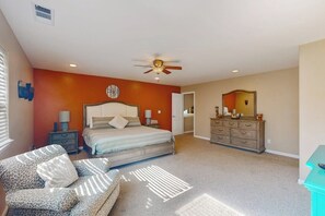 A bedroom with a bed, a dresser, a chair, and a ceiling fan. - Creekside & Cozy - Pool, Fireplace & Dog-Friendly (Bass Lake)
