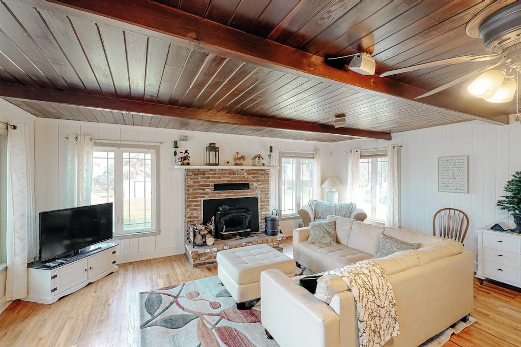 A living room with a fireplace, a television, and a sofa.