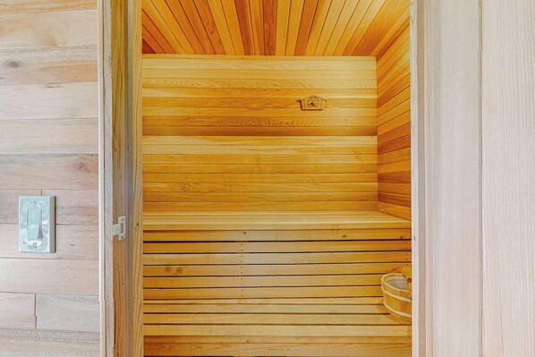A sauna with wooden slats and a metal handle.