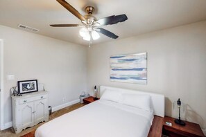 A bedroom with a bed, a nightstand, a dresser, a ceiling fan, and a painting on the wall. - Putney Place - Hot Tub & Mountain Views (North Fork)