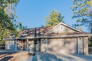 A single-story house with a garage, a front porch, and a small window. - Murray Lake Retreat - Near Bass Lake, Fireplace (Bass Lake)