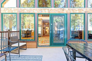 A building with large windows, outdoor seating, and a stone facade. - Oso Lodge - Ping-Pong, Deck & EV Charger (Yosemite West)