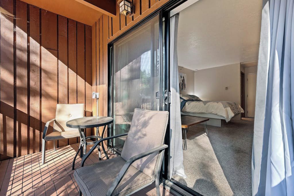 A room with a bed, a small table, and a chair.