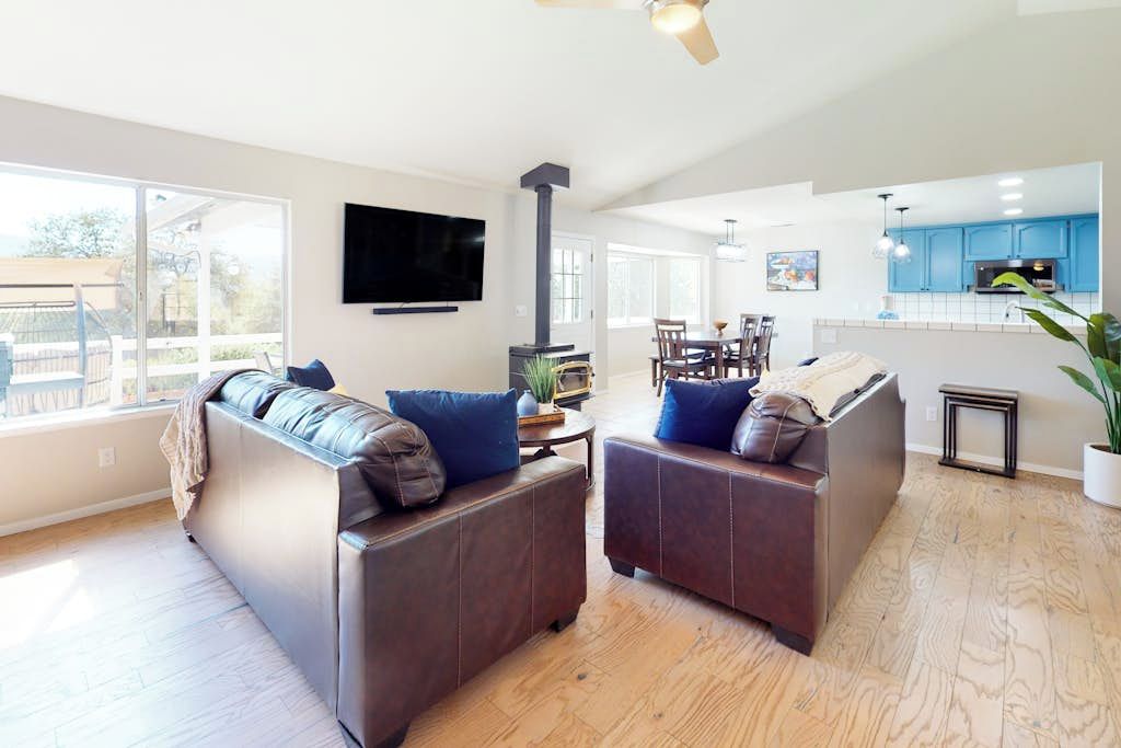 A modern living room with a sofa, a flat-screen TV, and a fireplace.