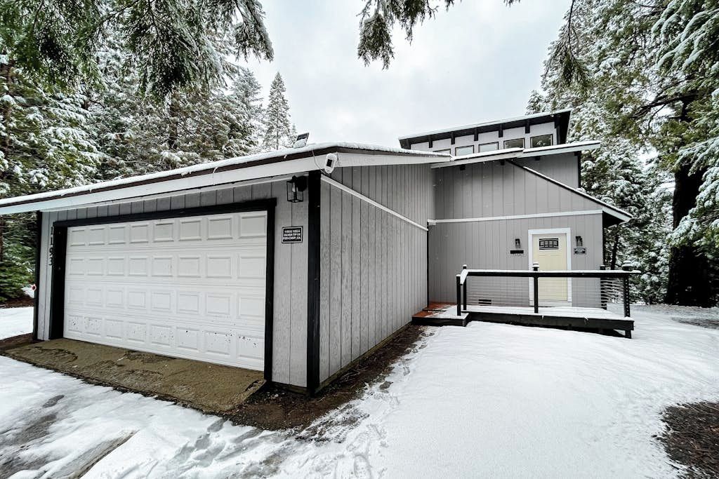 A two-story building with a garage and a covered porch area.