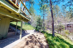 A covered outdoor area with a staircase leading to a building, surrounded by trees. - Miglin Lakeview - Lake Views & Private Boat Slip (Bass Lake)