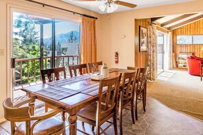 A dining area with a table and chairs, a ceiling fan, and a view of the outdoors. - Miglin Lakeview - Lake Views & Private Boat Slip (Bass Lake)