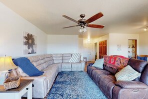 A living room with a sectional sofa, a ceiling fan, and a patterned rug. - Yosemite Portal - Mountain Views, Deck & Dogs OK (Oakhurst)