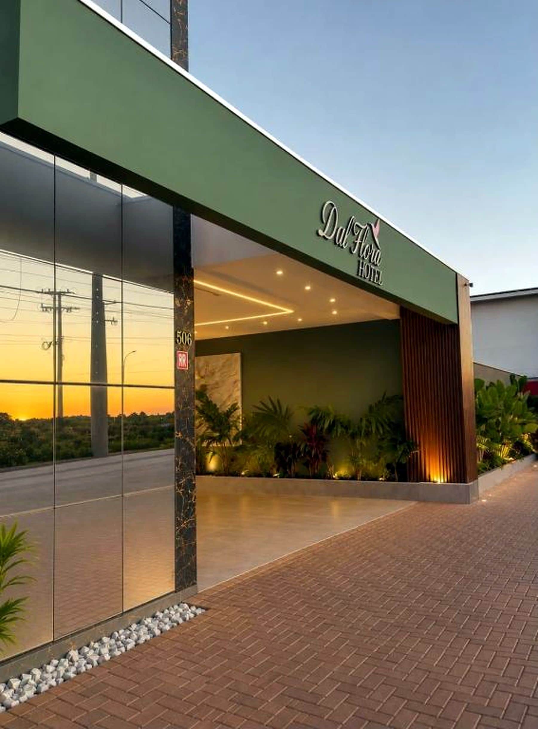 The exterior of the Dalhito Hotel with a modern facade, large glass entrance, and a well-lit entrance area.