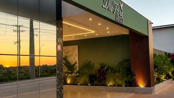 The exterior of the Dalhito Hotel with a modern facade, large glass entrance, and a well-lit entrance area.