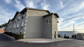 A multi-story hotel with a modern design, featuring a flat roof and a symmetrical facade.