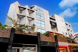 A modern building with a stone facade, large windows, and a sign that reads 'Collection.' - Super Collection O Circus Avenue Road (Kolkata)