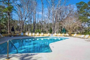A swimming pool with lounge chairs and a clear sky. - Village House 204 | Relax & Walk to the Beach (Hilton Head Island)