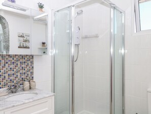 A modern bathroom with a glass-enclosed shower, a tiled backsplash, and a marble countertop. - Elberry Cove View (Paignton)