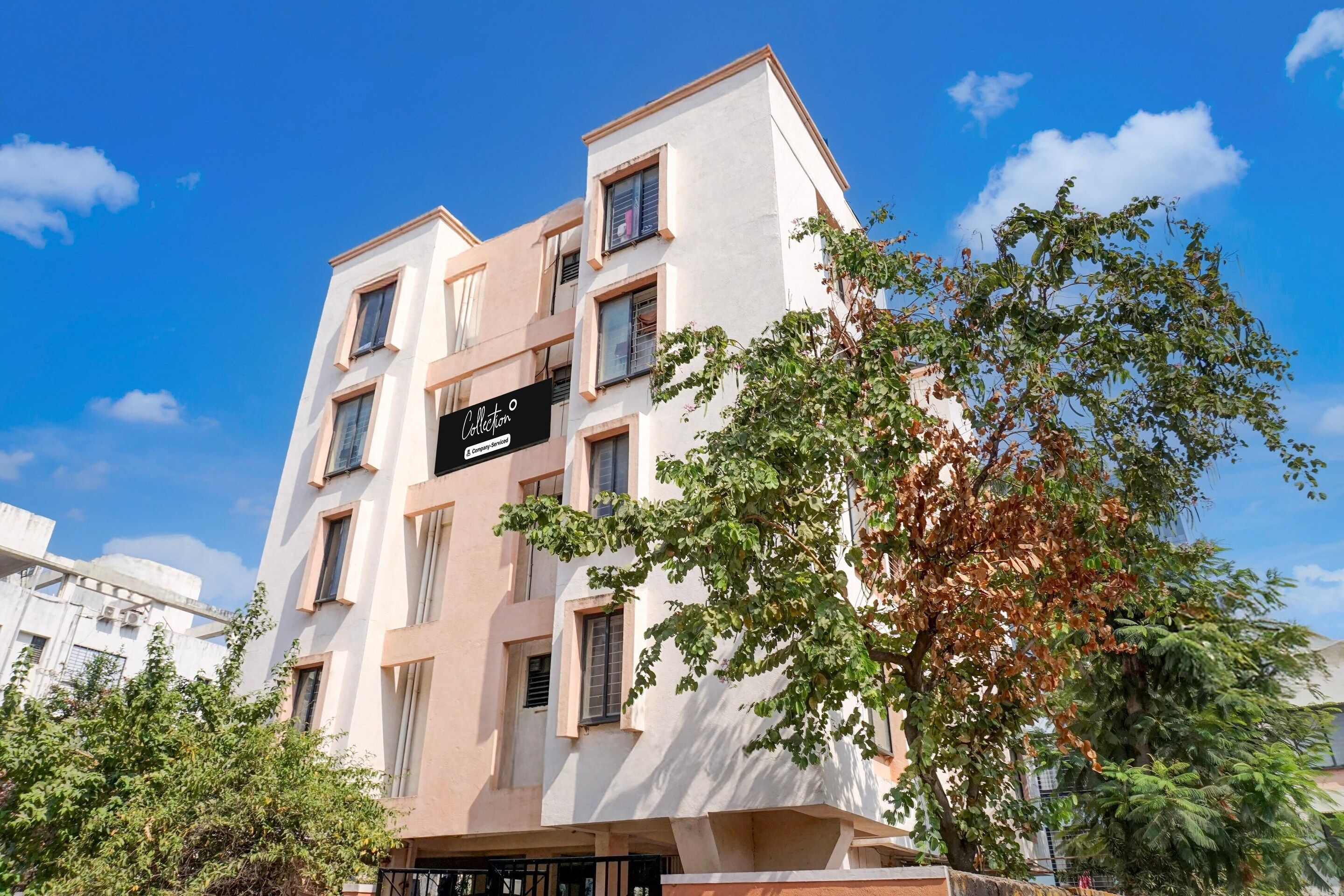 A multi-story building with a sign indicating it is a collection and company-serviced property.