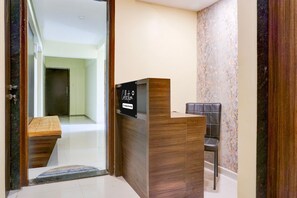 A reception desk with a sign indicating it's a company-serviced collection point. - Deluxe Zudio 7 Baner (Pune)
