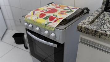 A kitchen with a stove, oven, and a countertop.