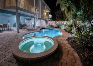 A pool area with two hot tubs and a lounge chair area. - Banana Cabana- Perfect Location (Holmes Beach)
