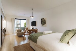 A hotel room with a bed, a desk, a chair, a TV, and a window. - Hestia at Casa Solado (Buenos Aires)