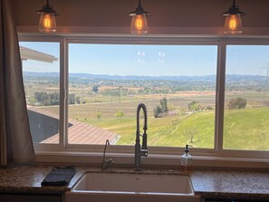 A kitchen with a large window, a sink, and a faucet. - Amazing Ranch Home located on a 155 acre ranch 10 minutes from downtown Paso. (Paso Robles)