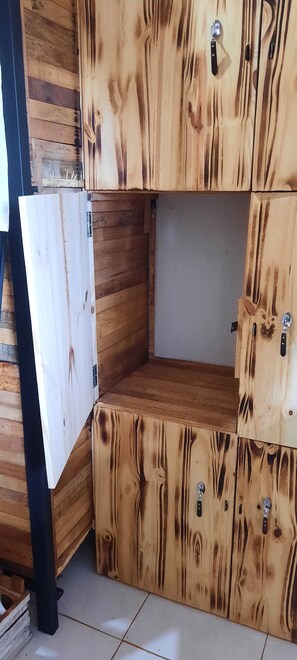 A room with a wooden cabinet and a white door.