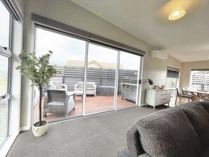 A spacious living area with a sliding glass door leading to an outdoor patio.