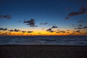 Ein Strand mit Sonnenuntergang und Meerblick.