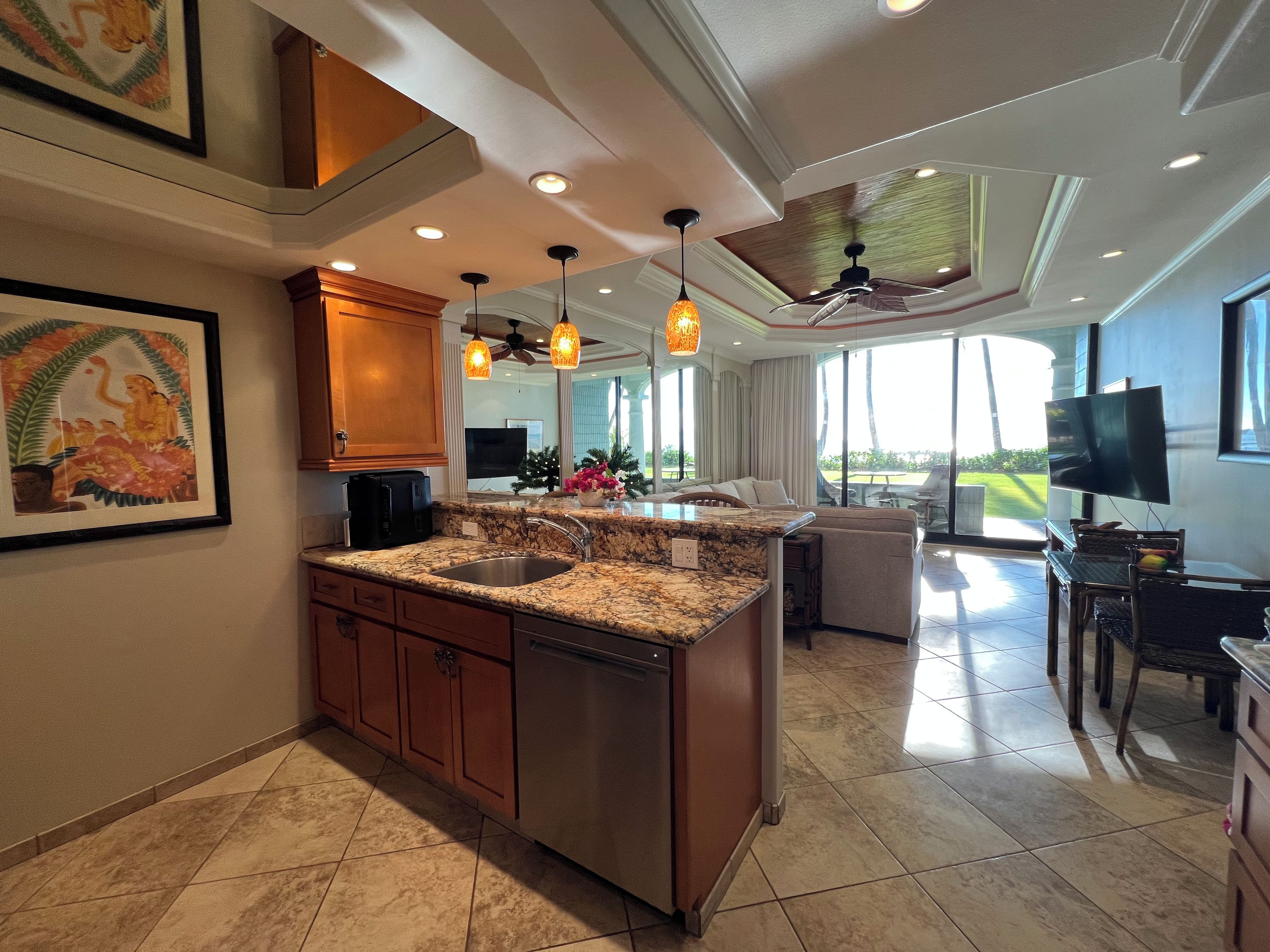 A modern kitchen with granite countertops, wooden cabinets, and a built-in island.