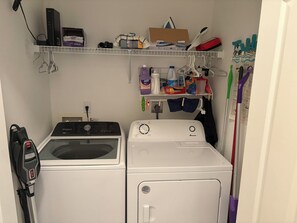 A laundry room with a Whirlpool washer and a front-loading Amana dryer. - Cozy 2-bedroom condo centrally located in beautiful Bonita Springs (Bonita Springs)