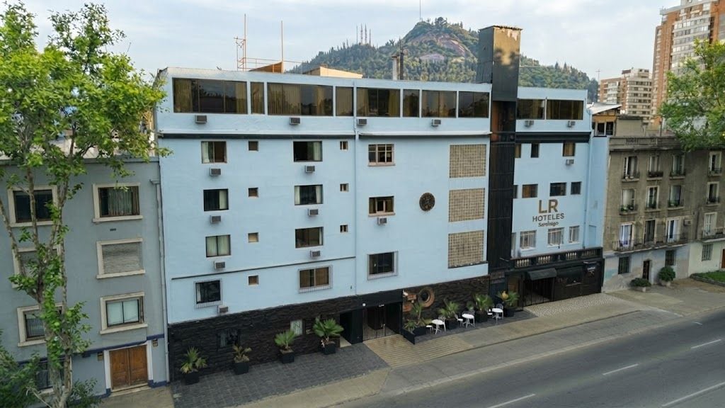 A hotel building with multiple floors, a flat facade, and a sign indicating it is a hotel.