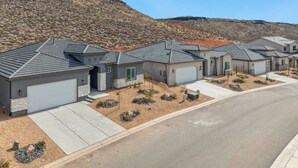 A residential area with houses featuring grey roofs and stone accents, surrounded by a hilly landscape. - 3 Master Suites with Private Baths, Kings Beds, Private Hot Tub, EV, BBQ (Washington)
