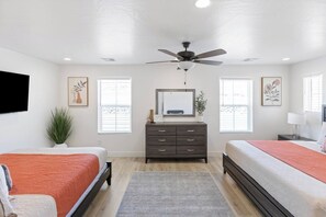 A bedroom with two beds, a dresser, a ceiling fan, and artwork on the walls. - Close to National and State Parks - Heated Pool, Hot Tub, Bunk Beds (Washington)