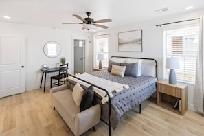 A bedroom with a bed, a desk, a chair, a sofa, a bedside table with a lamp, a ceiling fan, and a window with blinds. - Close to National and State Parks - Heated Pool, Hot Tub, Bunk Beds (Washington)