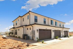 A two-story house with a garage, numbered 2258, and a clear view of the surrounding landscape. - Close to National and State Parks - Heated Pool, Hot Tub, Bunk Beds (Washington)