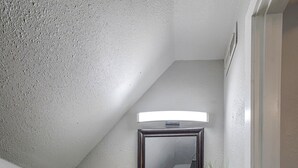 A bathroom with a wooden vanity, a mirror, a toilet, and a plant. - 5 Minutes to KU Med • Fast Wi-Fi • Pet-Friendly • In-Unit Washer & Dryer (Kansas City)