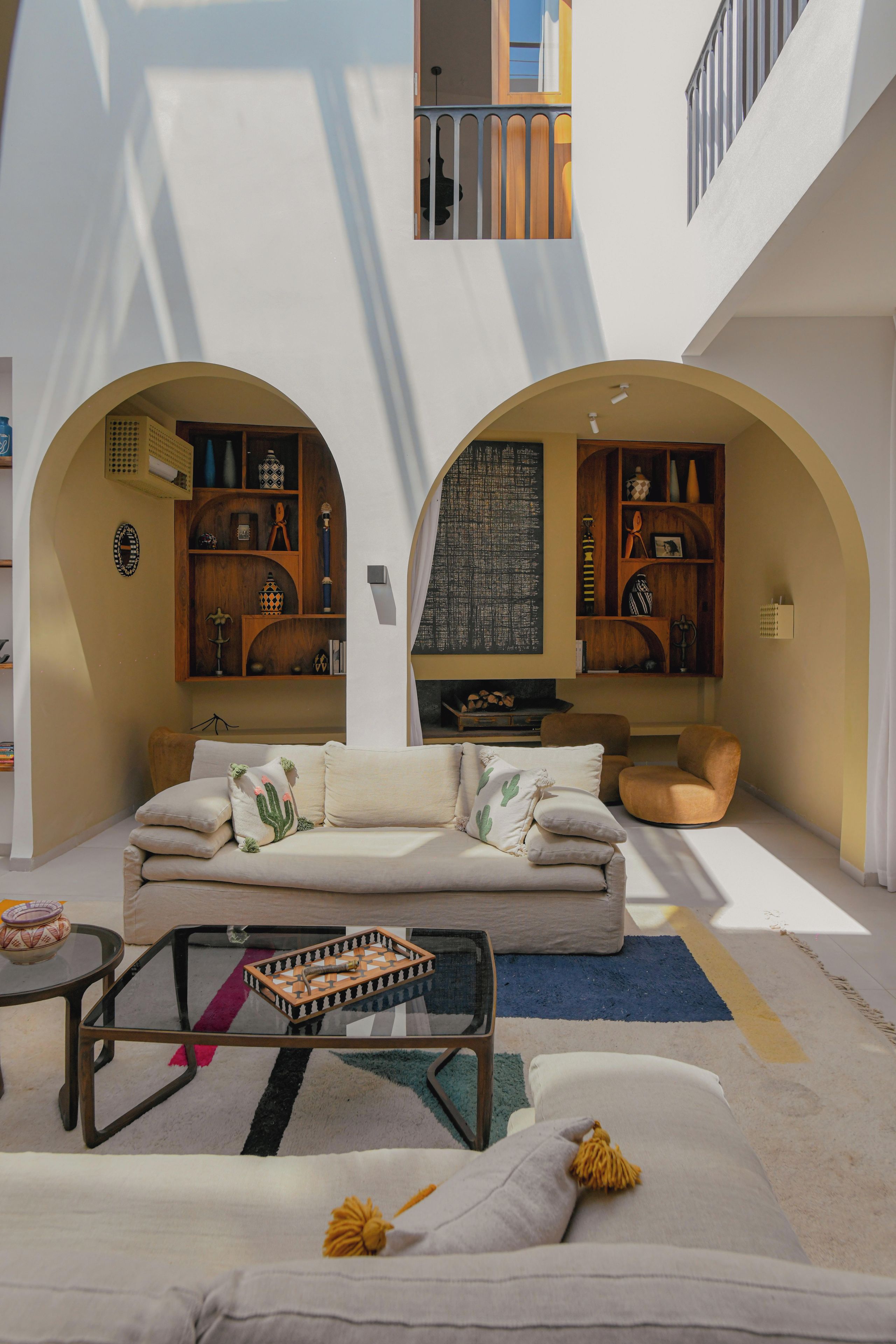 A spacious living area with a sofa, coffee table, and decorative items.