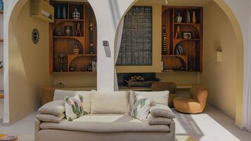 A spacious living area with a sofa, coffee table, and decorative items.