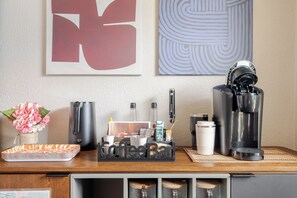 A coffee station with a coffee maker, cups, and a mug. - Private Home with Jacuzzi and Large Deep Pool close to NRG/Galleria/Downtown (Houston)
