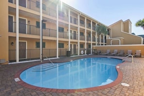 A hotel with a swimming pool, multiple balconies, and a brick-paved area. - Coral Reef Ground level unit 10 Epic Views! (Destin)