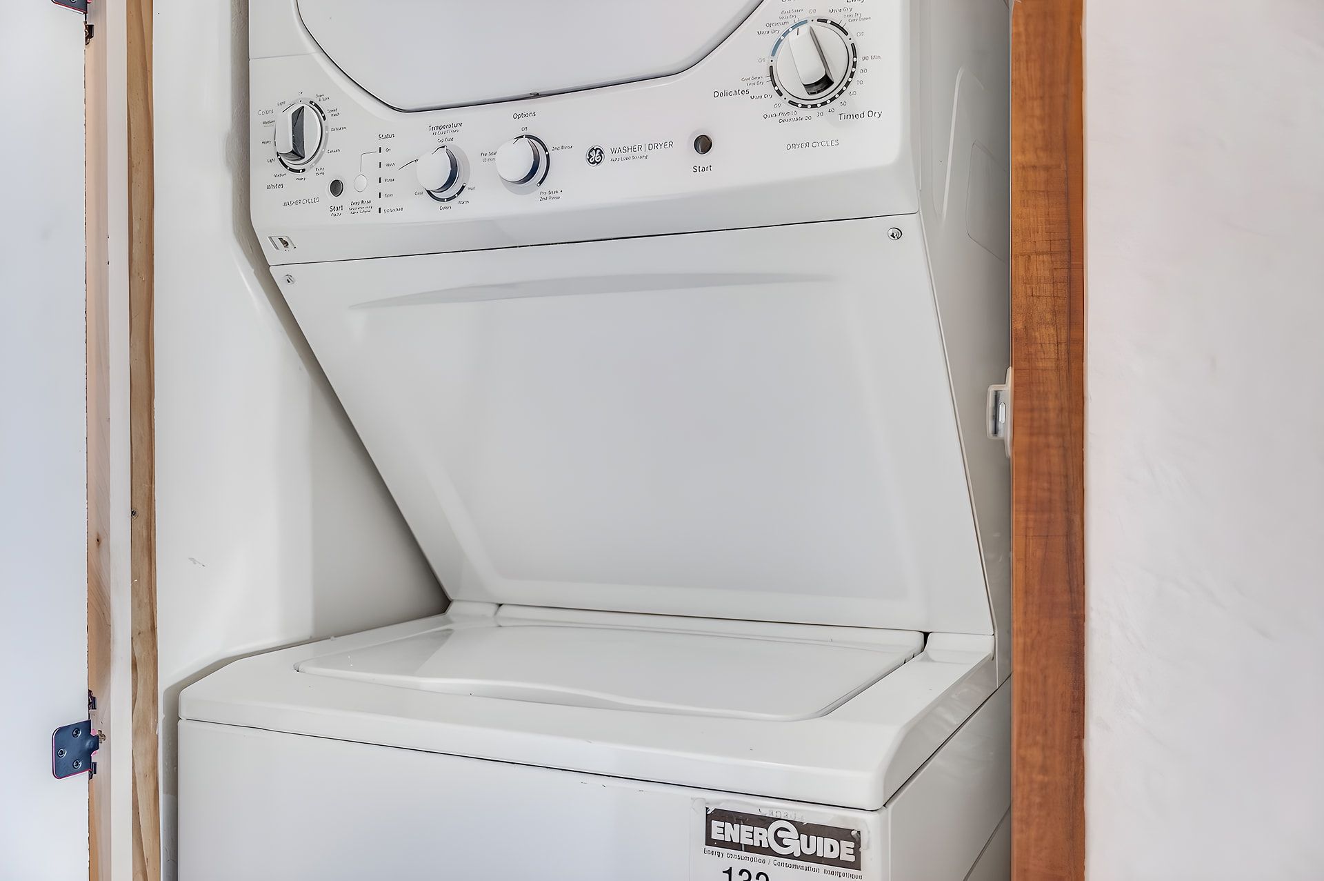 A white washer and dryer unit with control knobs and a label reading 'ENERGUEGUIDE.'