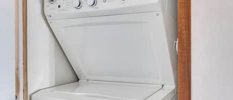 A white washer and dryer unit with control knobs and a label reading 'ENERGUEGUIDE.'