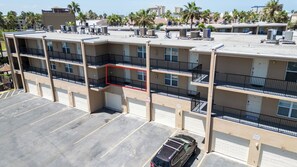 A multi-story parking garage with a car parked in the lower level. - 2BR Half Block to Beach, Garage, Heated Pool (South Padre Island)