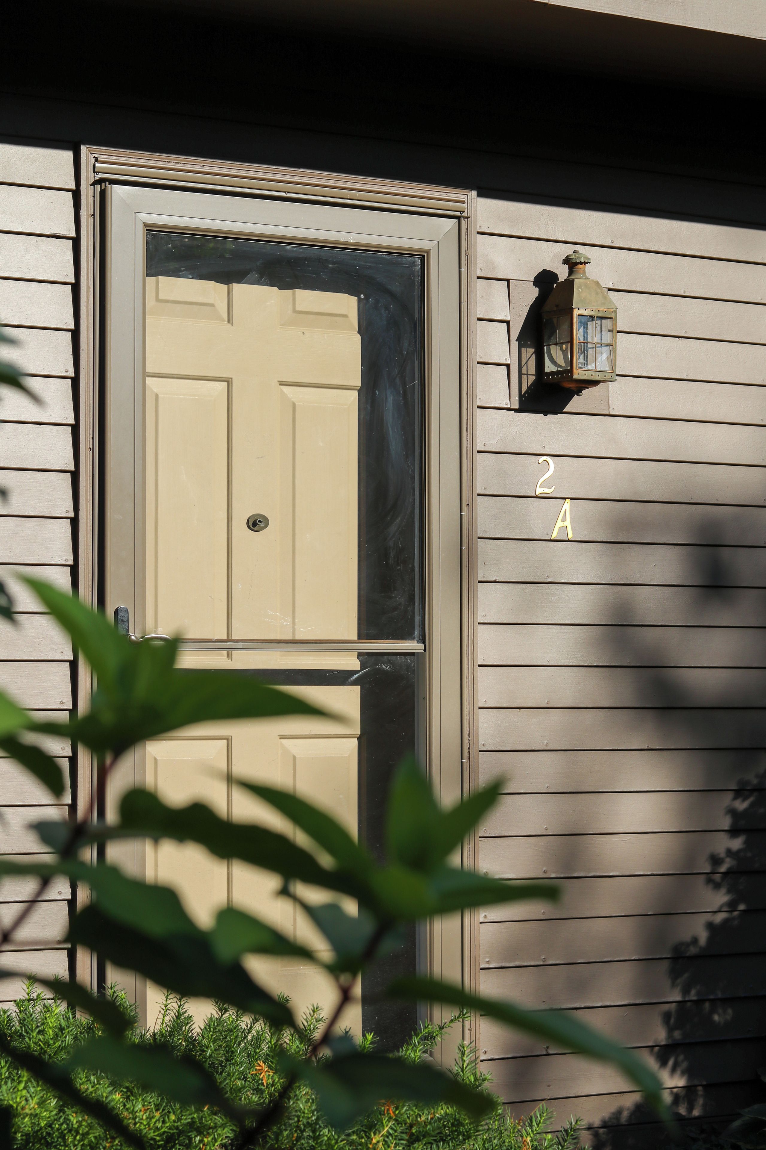 A house with a double door, a mailbox, and a number '2A' on the wall.