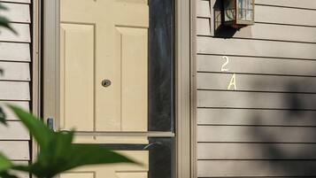 A house with a double door, a mailbox, and a number '2A' on the wall.