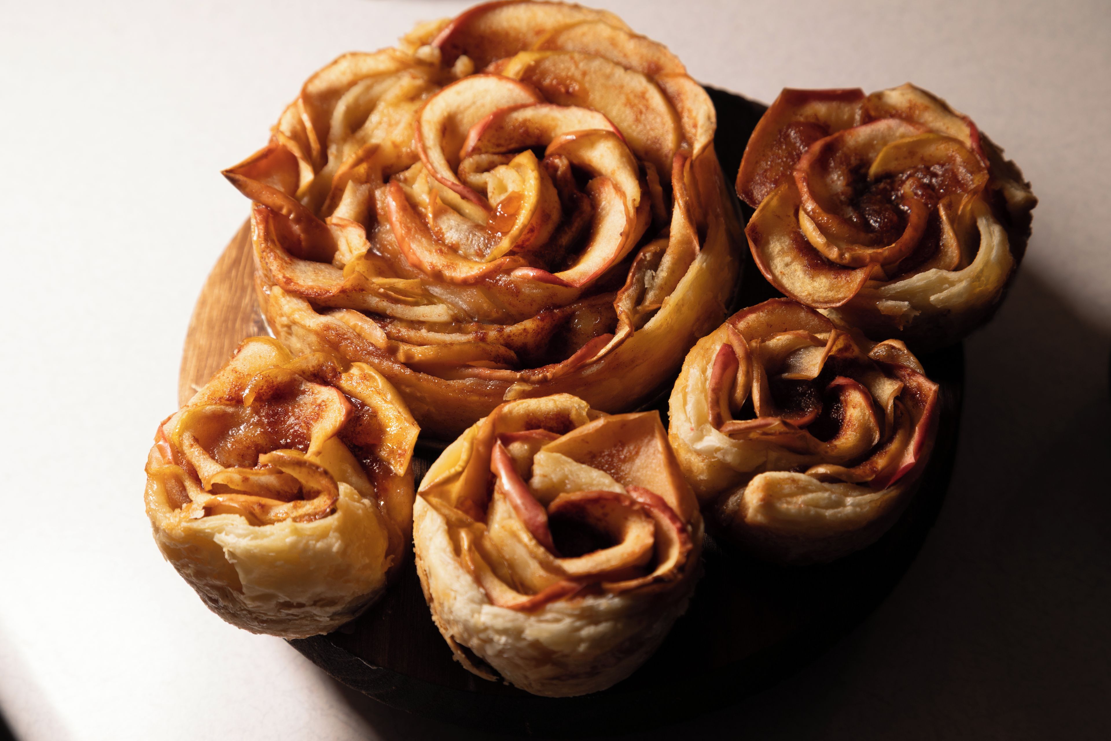 A wooden table with several pastries.