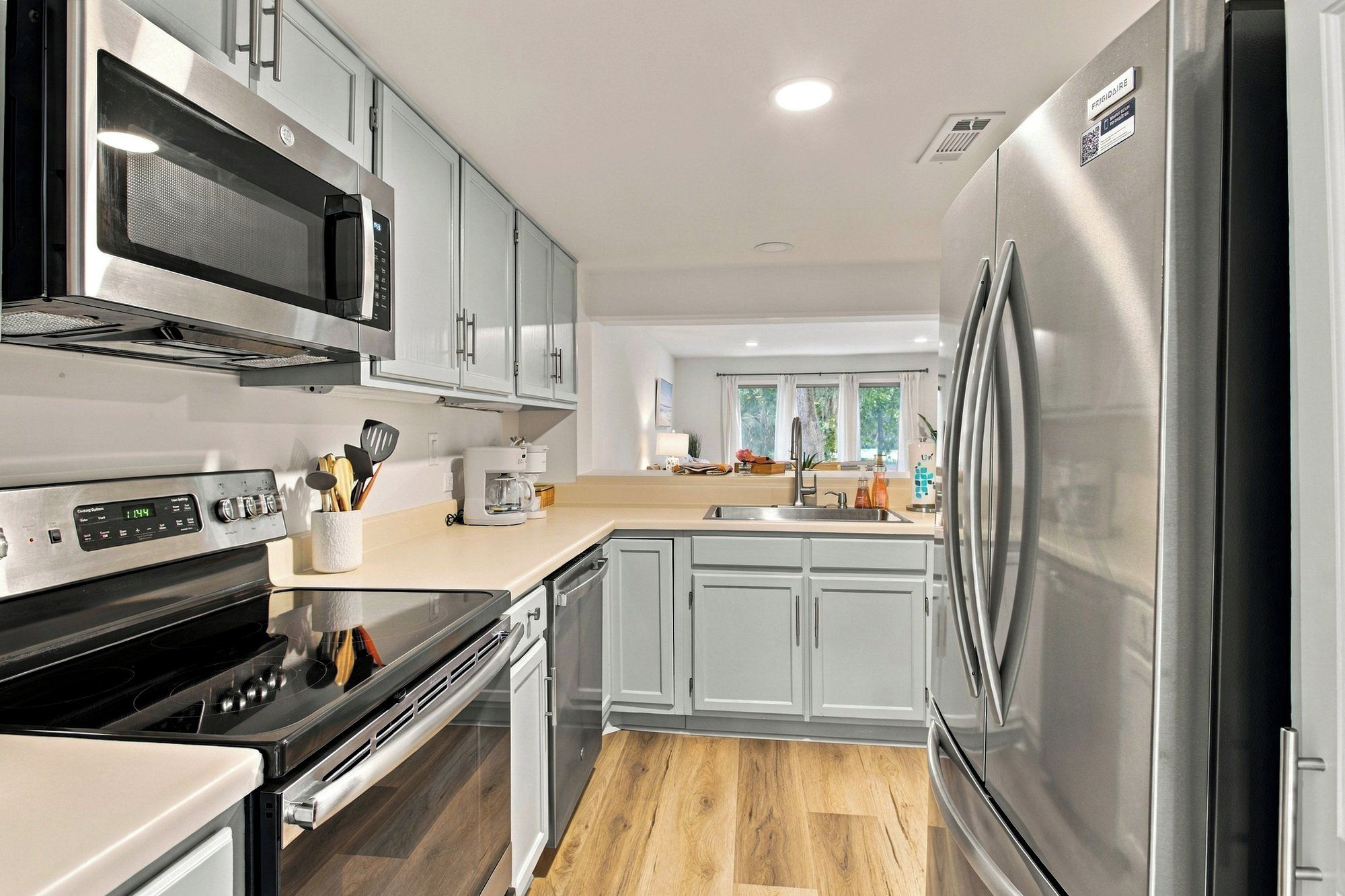 A modern kitchen with stainless steel appliances, a built-in oven, and a microwave.